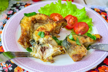 Mackerel in a frying pan with onions