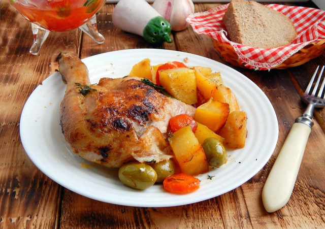 Potatoes with chicken on a baking sheet baked in the oven