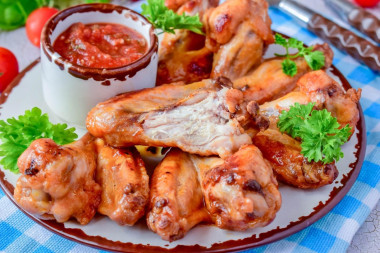 Wings in honey sauce in a frying pan