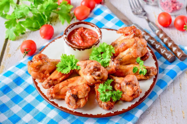 Wings in honey sauce in a frying pan