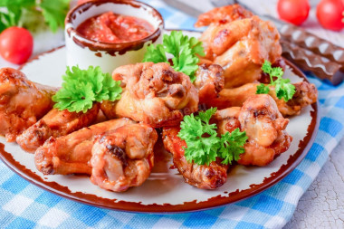 Wings in honey sauce in a frying pan