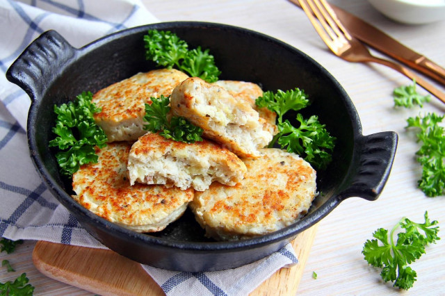 Pollock cutlets in a frying pan