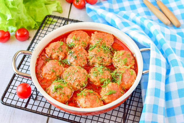 Meatballs with tomato paste gravy in a frying pan