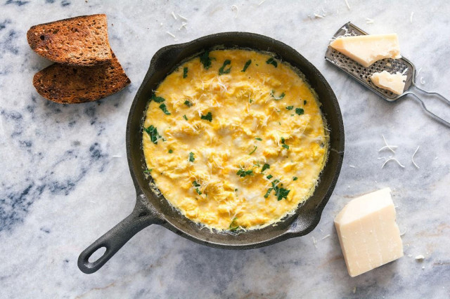 Omelet with sour cream in a frying pan