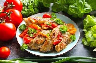 Delicious pork ribs in a frying pan stewed with vegetables