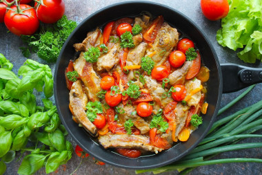 Delicious pork ribs in a frying pan stewed with vegetables