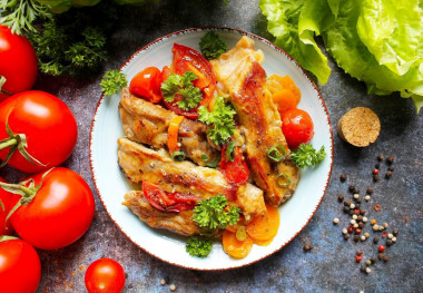 Delicious pork ribs in a frying pan stewed with vegetables