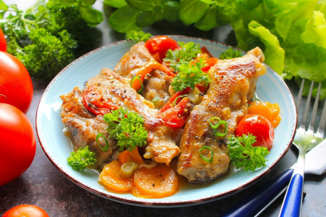 Delicious pork ribs in a frying pan stewed with vegetables