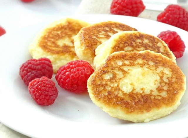 Cheesecakes made of oatmeal and cottage cheese on frying pan