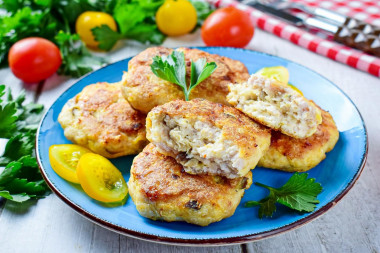 Chicken cutlets with mushrooms and cheese in the oven