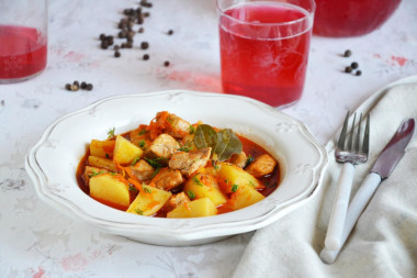 Stewed potatoes with meat in a frying pan