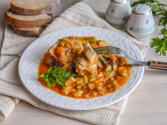 Pollock stewed with vegetables in a frying pan