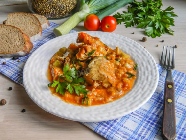 Pollock stewed with vegetables in a frying pan