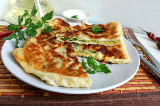 Pita bread with cottage cheese and egg in a frying pan