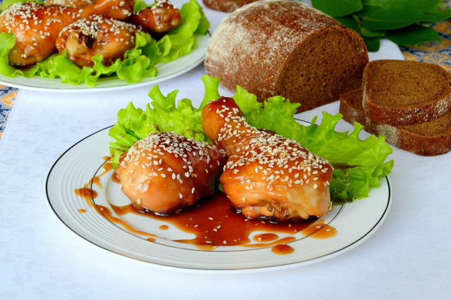 Chicken drumsticks in soy sauce on frying pan