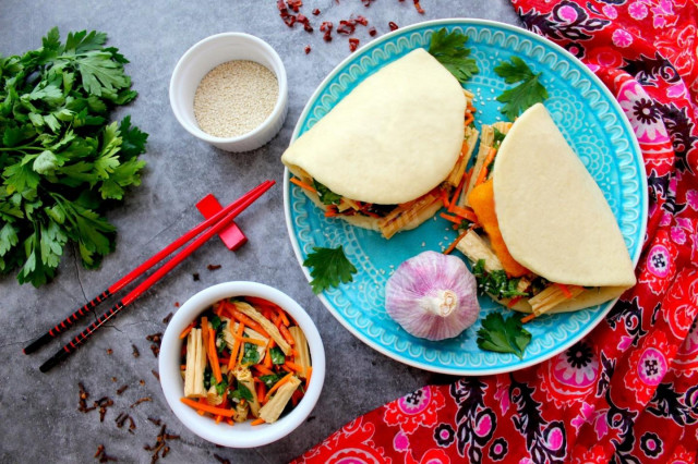 Steamed bao buns with fish cutlet and asparagus salad