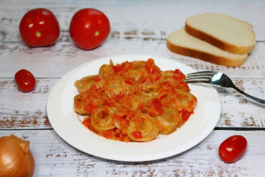 Dumplings with tomatoes in a frying pan