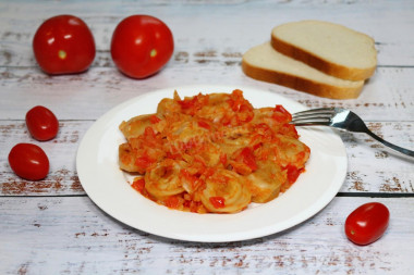 Dumplings with tomatoes in a frying pan