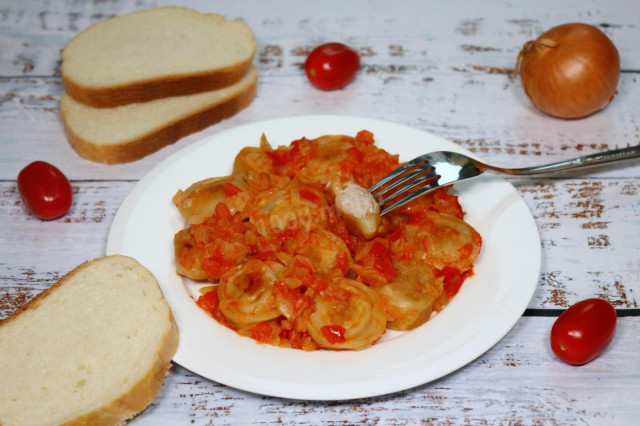 Dumplings with tomatoes in a frying pan