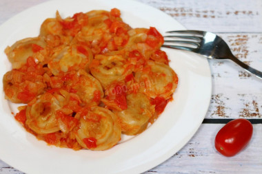 Dumplings with tomatoes in a frying pan