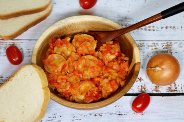 Dumplings with tomatoes in a frying pan