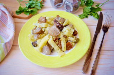 Potatoes with mushrooms in a frying pan with sour cream