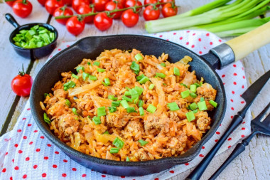 Stewed cabbage with minced meat and rice in a frying pan