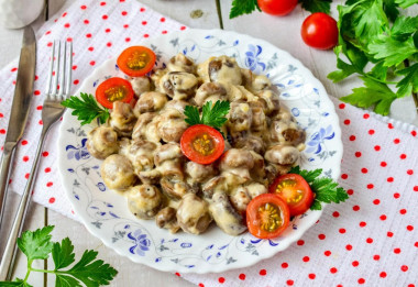 Mushrooms in cream with cheese in a frying pan