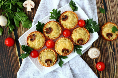 Julienne with mushrooms in tartlets in the oven