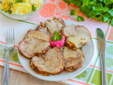 Pork neck baked in the oven in a whole piece