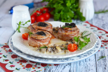 Pork tenderloin with prunes in bacon with sauce