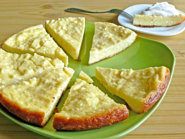 Cottage cheese casserole in a frying pan with lemon zest
