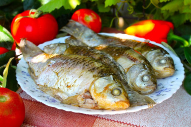 Crucian carp on coals in foil with sour cream