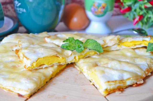 A snack of pita bread with an egg, cheese and herbs