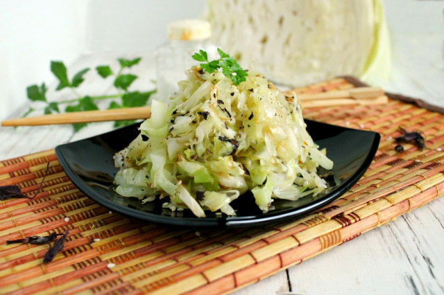 White cabbage with sesame seeds in a frying pan