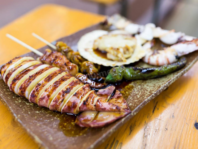 Squid with ginger powder and garlic in syrup on grill