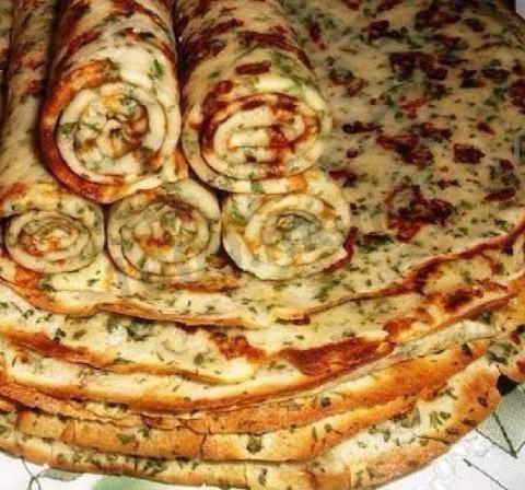 Cheese pancakes with fresh herbs on a baking sheet