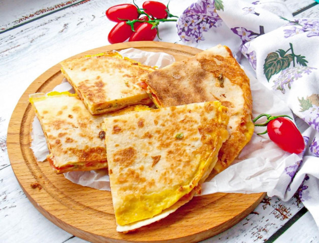 Tortilla cake with filling in a frying pan