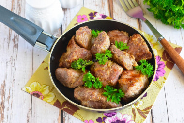 Pork shish kebab in a frying pan