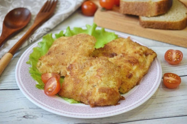 Pollock fillet in batter and breadcrumbs in a frying pan