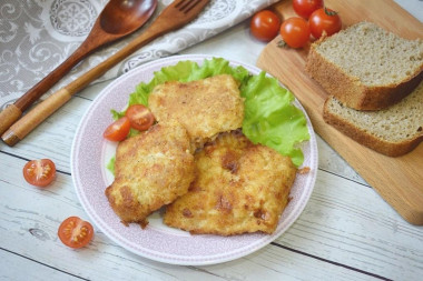 Pollock fillet in batter and breadcrumbs in a frying pan