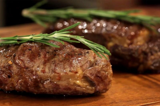 Beef steak with rosemary in a grill pan