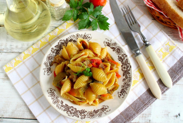 Pasta with mushrooms and vegetables in a frying pan