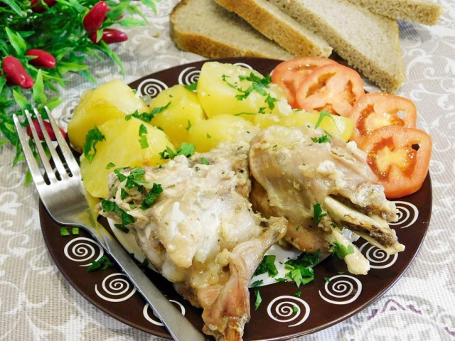 Rabbit stewed in sour cream with potatoes