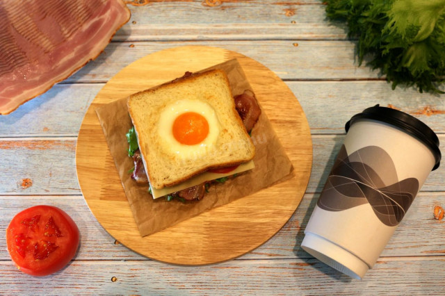 Crispy toast for breakfast with vegetables, bacon and egg
