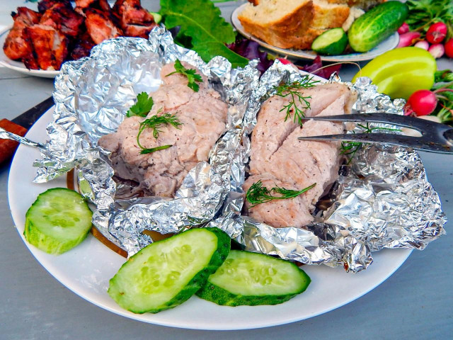 Pork tenderloin in foil on coals