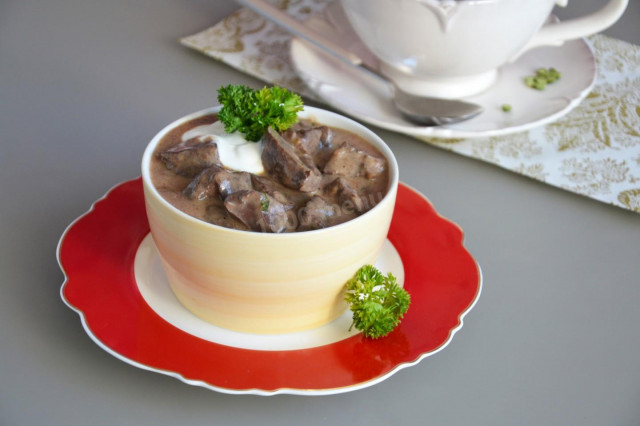 Beef liver in sour cream in a frying pan