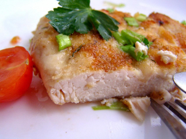 Chicken breast chop with cheese in a frying pan