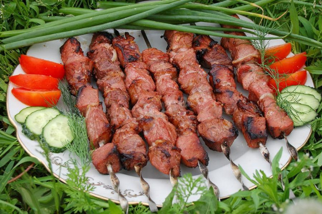 Shish kebab of nutria meat on coals