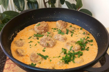 Beef meatballs with tomato and sour cream sauce on sour cream